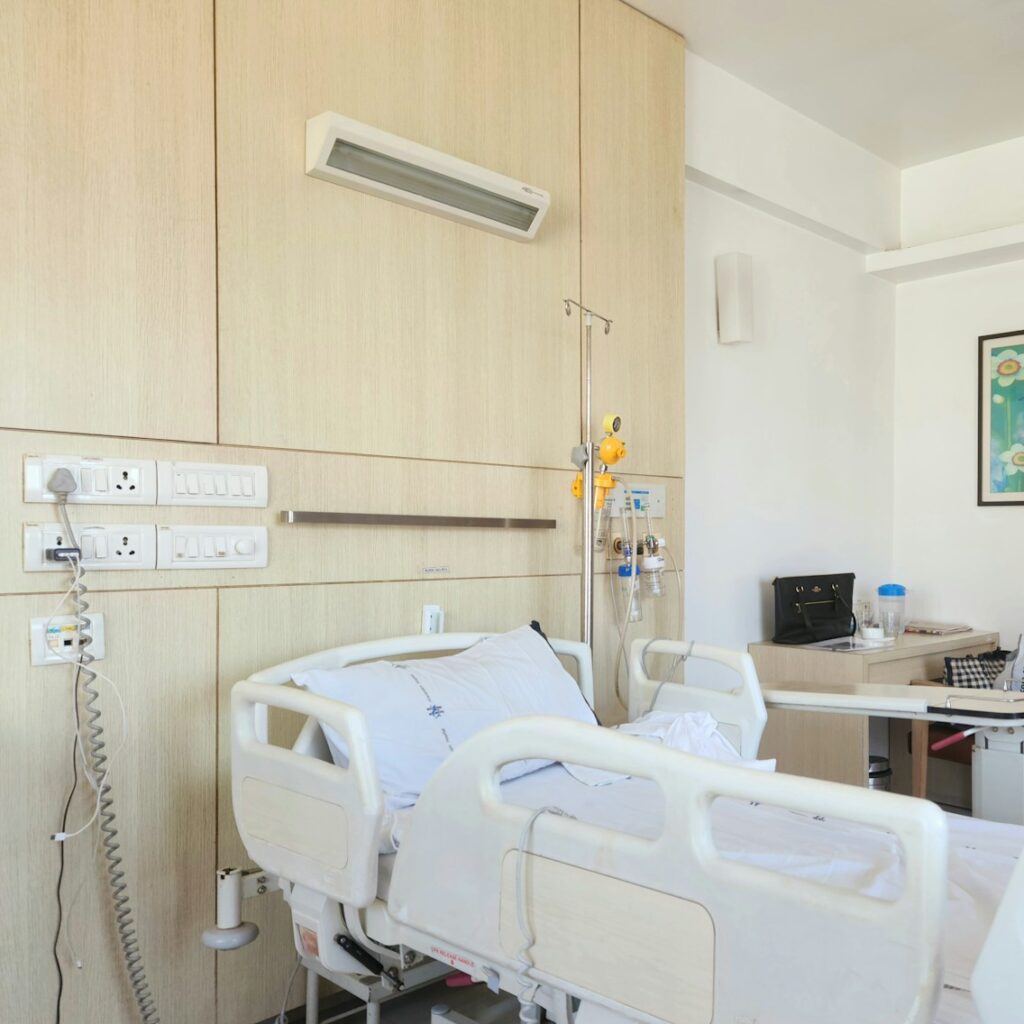 a hospital room with a bed and a desk